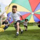 The state of preschool 2022: children playing under colorful circle tarp