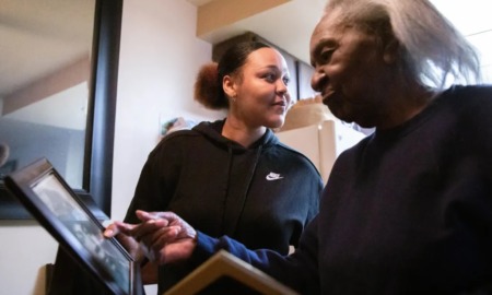 toll of his absence; women supporting prisoner Almeer Nance: older black woman looking at photo while younger woman looks off to the right