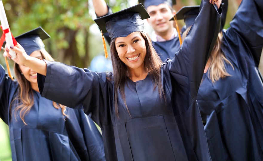 DEI in colleges: young woman in graduation garb celebrating