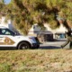 Ryan Gainer - When police encounters with autistic people turn fatal: a police officer walks away from a San Bernardino sheriff's car with gun in hand