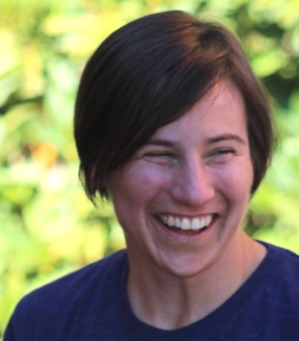 YTAC: Meg Pittman headshot White woman with short brown hair smiles widely into camera