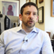 Newsmaker Casey Trupin headshot; man sitting in office in collared shirt