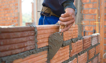 community, safety, workforce dev. grants; worker building brick wall