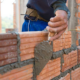 community, safety, workforce dev. grants; worker building brick wall