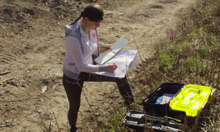 environment job and career training grant graphic, young woman doing survey work in the field