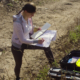 environment job and career training grant graphic, young woman doing survey work in the field