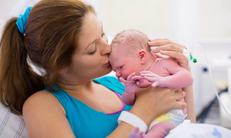 maternal health grants: mother in hospital kissing her newborn