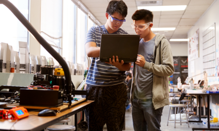 undergraduate STEM/computing education advancement grants; two college students in lab on laptop with safety goggles on