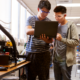 undergraduate STEM/computing education advancement grants; two college students in lab on laptop with safety goggles on