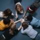 Underserved student education program evaluation grants; students laying in circle on floor learning