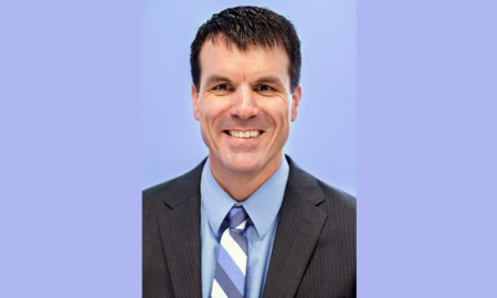 Greg Zweber newsmaker headshot; smiling man in suit and tie