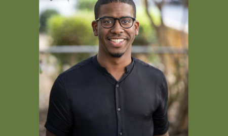 Child welfare advocacy: A man with glasses wearing a black shirt