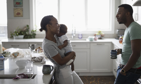 family instability and childrens social development report; happy african american family in kitchen