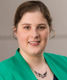 Disabled voter rights:V headshot white woman with light brown hair pulled back wearing light green jacket with black top